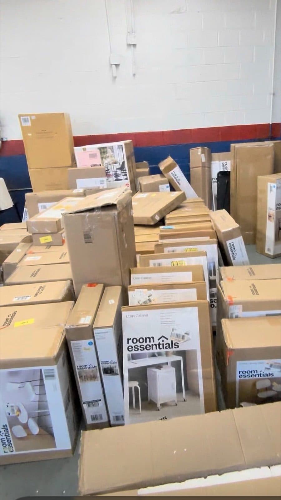 Pallets of boxed dorm furniture stacked at a Harrisonburg VA discount furniture warehouse