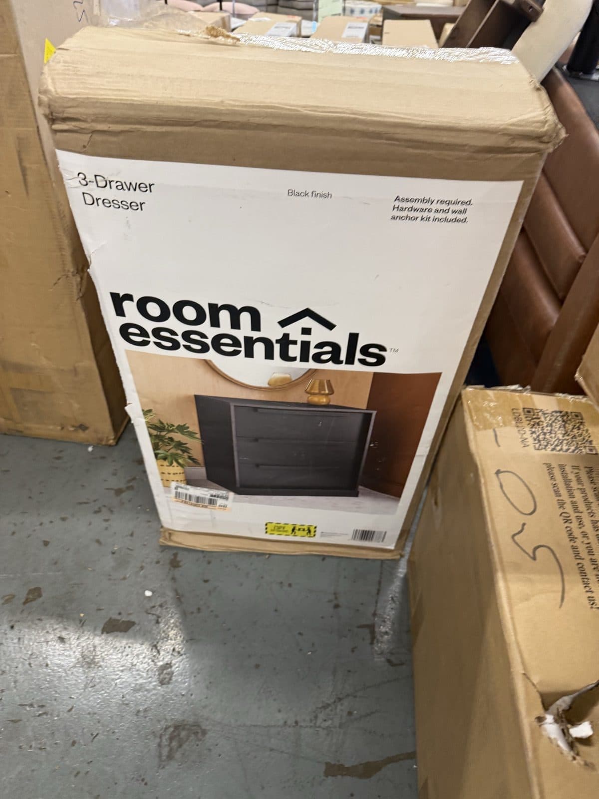 Three drawer dresser in a black finish, new in the box at a Harrisonburg VA furniture warehouse