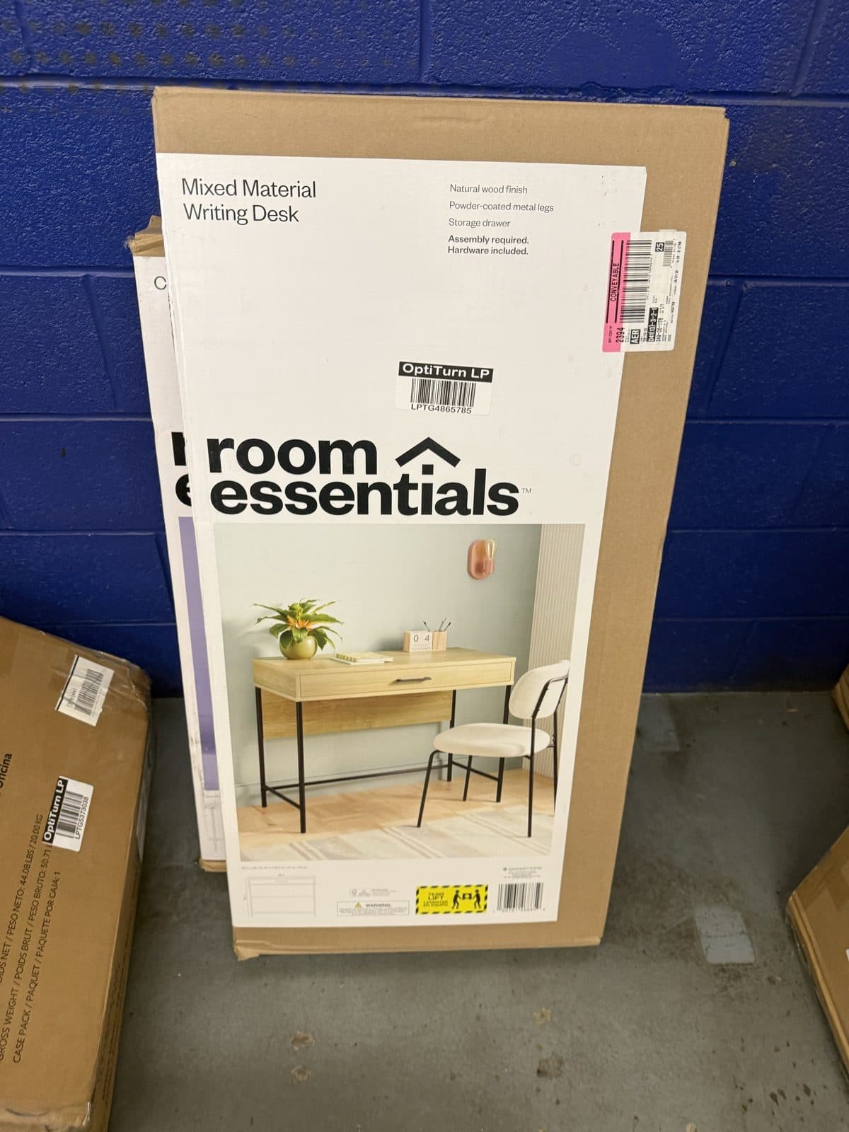 Boxed writing desk with a wood top and metal legs for a student apartment