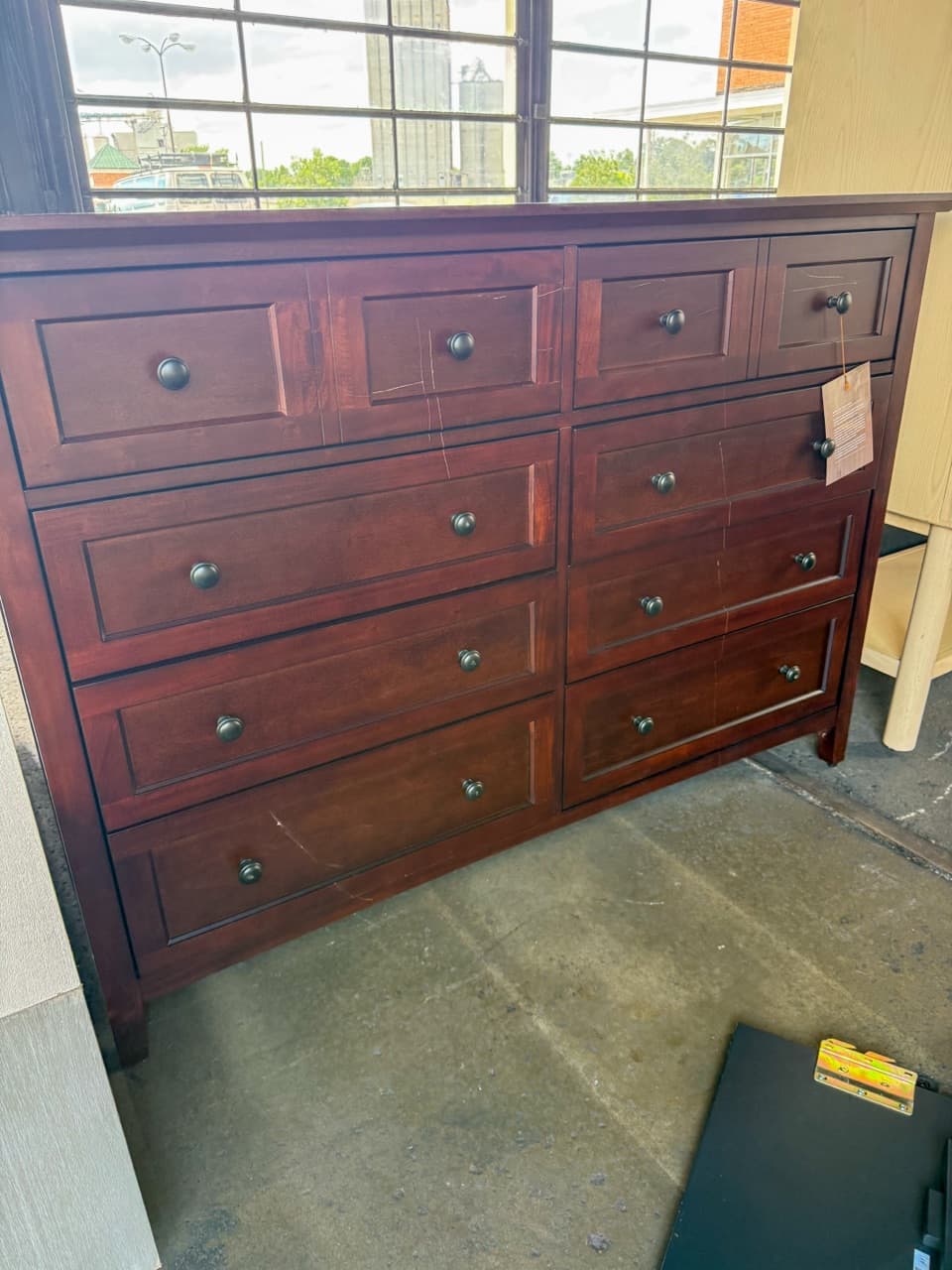 Solid wood eight-drawer dresser displayed inside the furniture warehouse