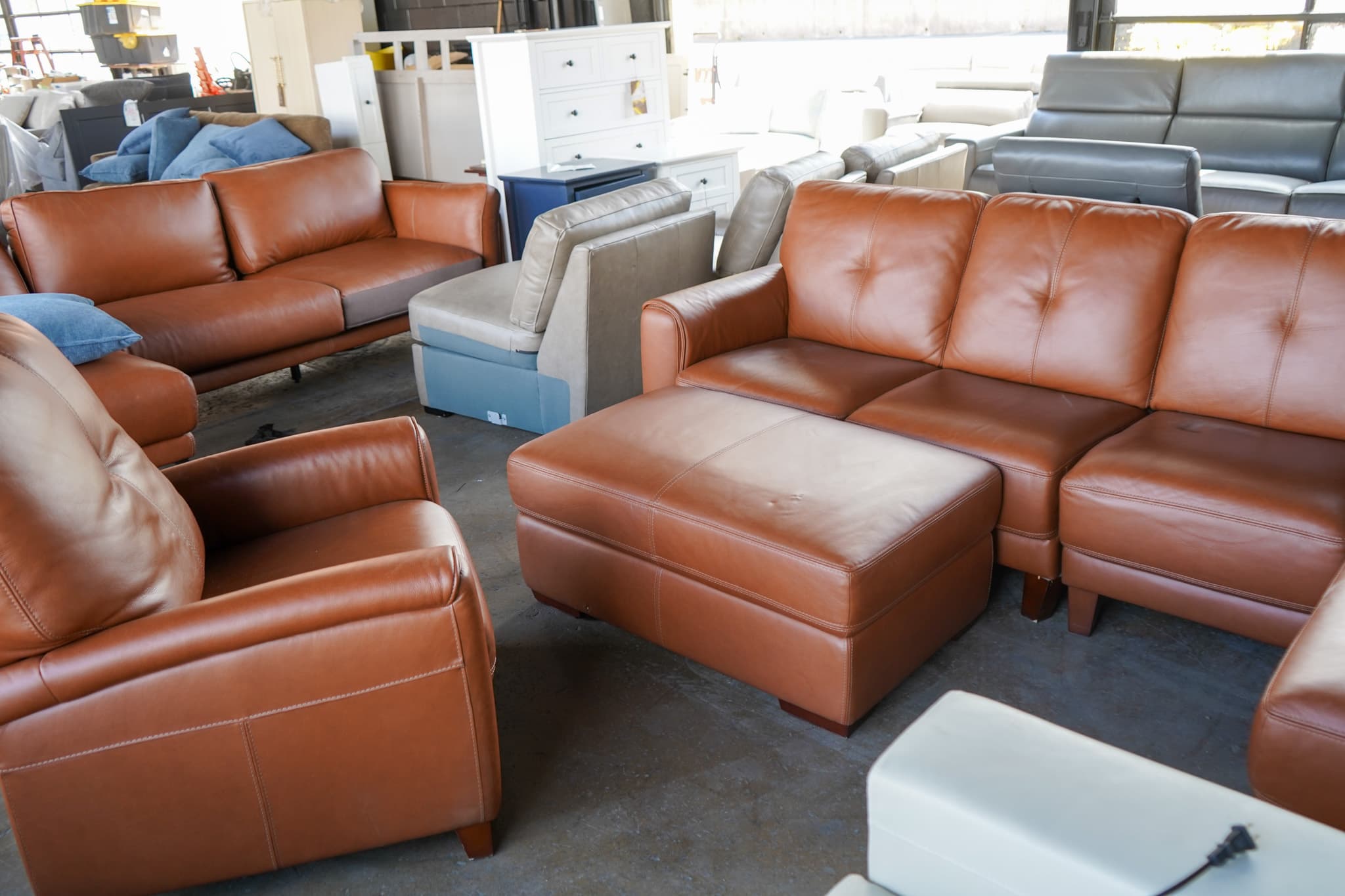 Aisle of discount sofas and loveseats at an overstock furniture store in Harrisonburg