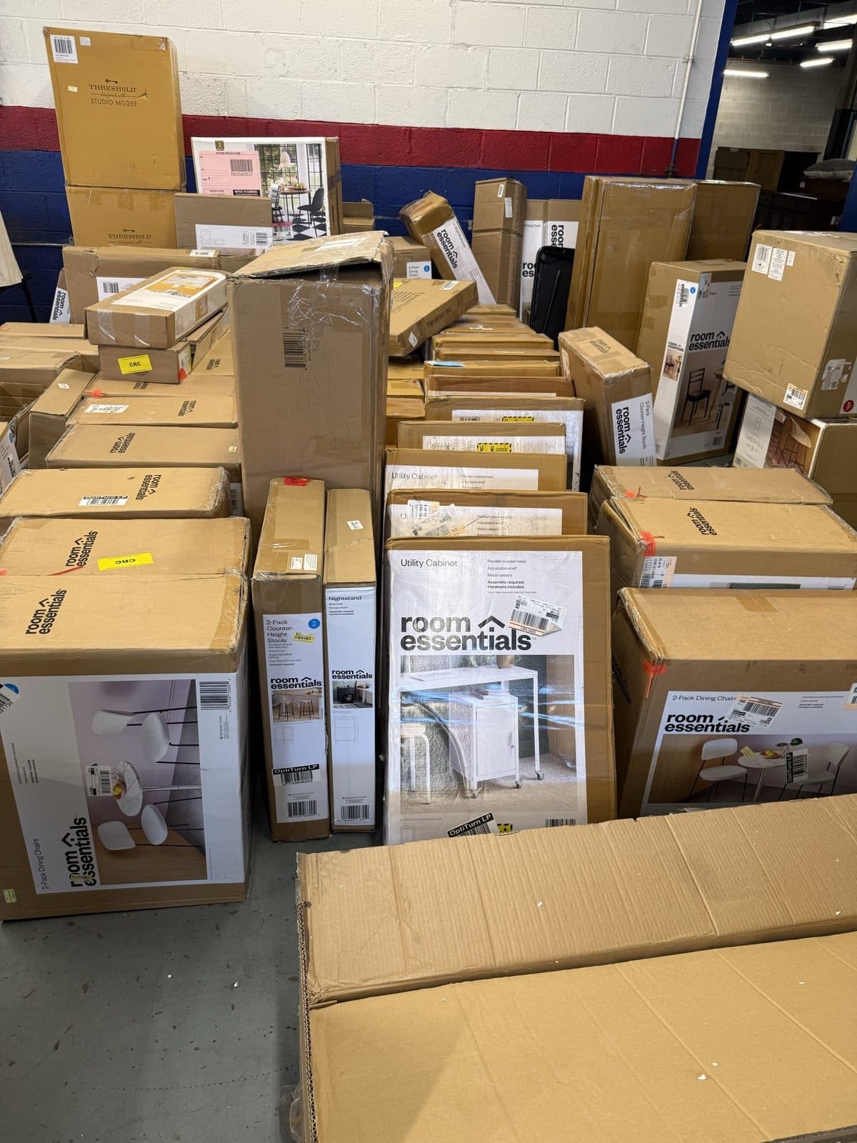 Boxed cabinets, nightstands and stools stacked on the warehouse floor in Harrisonburg VA